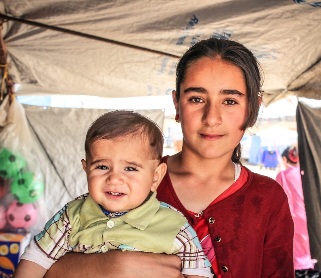 a woman holding a baby in her arms