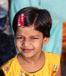 a little girl with a red bow on her head